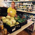 Paige Fowler, president elect of the Rotary Club of Harrisonville, sorts vegetables at Good Shepard's food pantry.