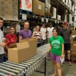 Members of Springfield Rotaract box up food at Ozarks Food Harvest.